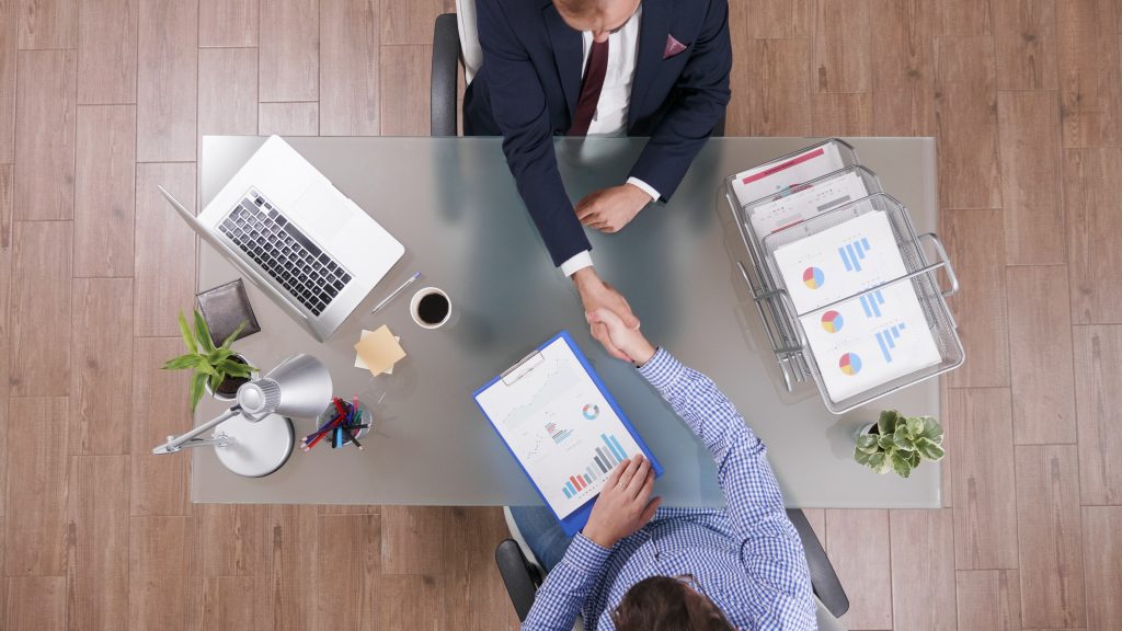 top-view-of-businessmen-shaking-hands